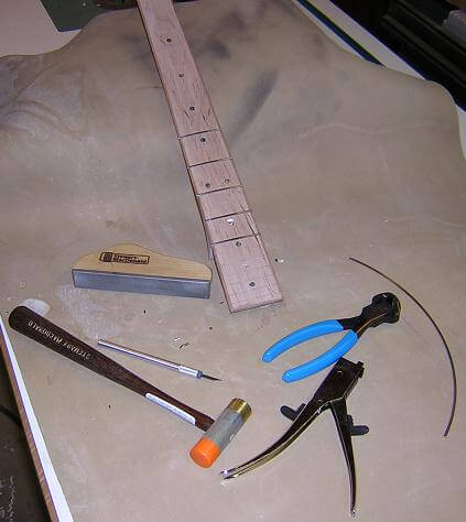 Installing the frets.