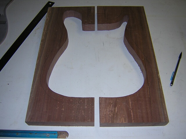 Cutting out the hollow portion of the guitar body.