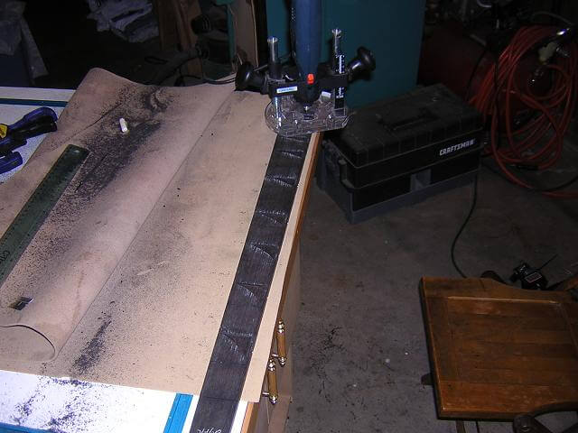 Routing the recesses for the fretboard inlays.
