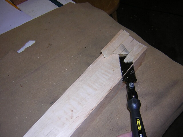 Finishing the neck angle cut with a flush trim saw.