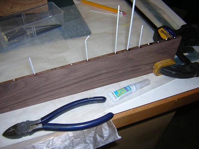 Gluing the fretboard dots in place.