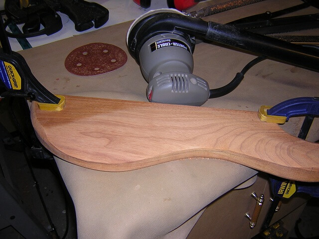 Sanding the belly contour smooth.