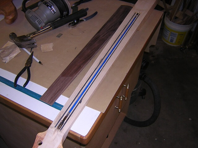 Installing the carbon fiber rods and truss rod.