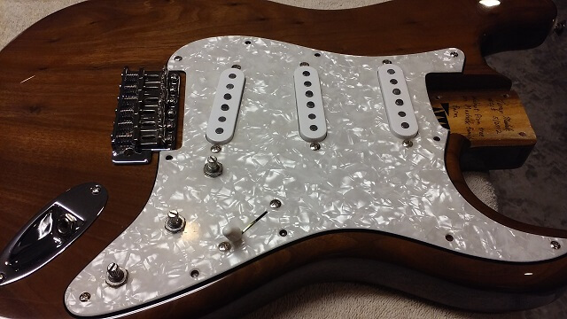 Installing the pickguard, output jack and the bridge.