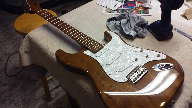 The front of the guitar with the neck attached.