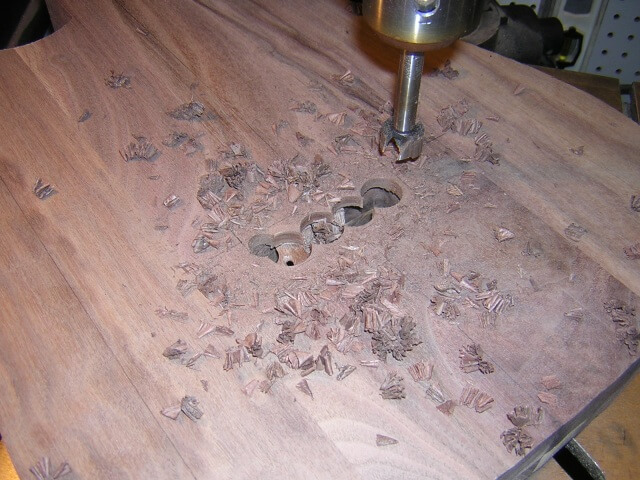 Removing excess wood at the drill press prior to routing the rear tremolo cavity.