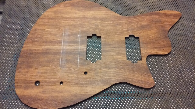 Cutting the holes for the controls and pickups in the top.