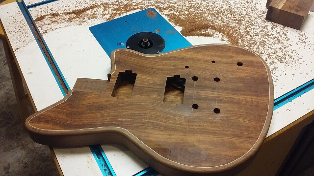 Rounding over the edges of the guitar.