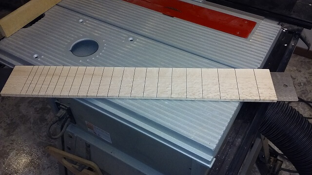 The slotted fretboard.