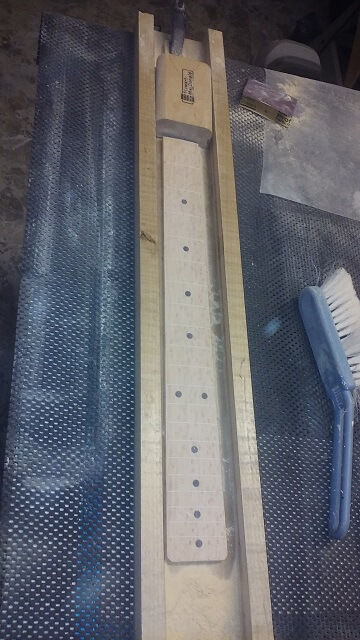 Sanding the radius into the face of the fretboard.