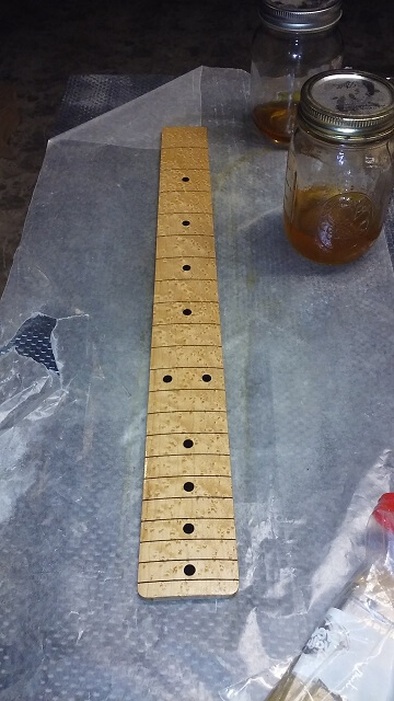 Giving the fretboard a coat of shellac.