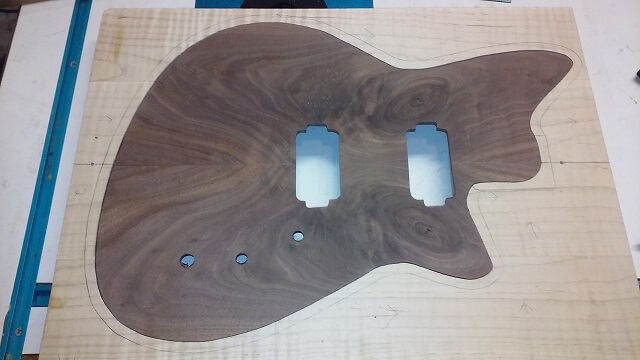 Cutting the holes for the pickups and controls on the front.