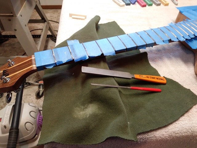 Crowning and polishing the frets.