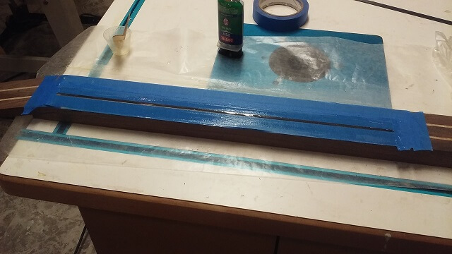 Gluing in one of the carbon fiber reinforcement rods.