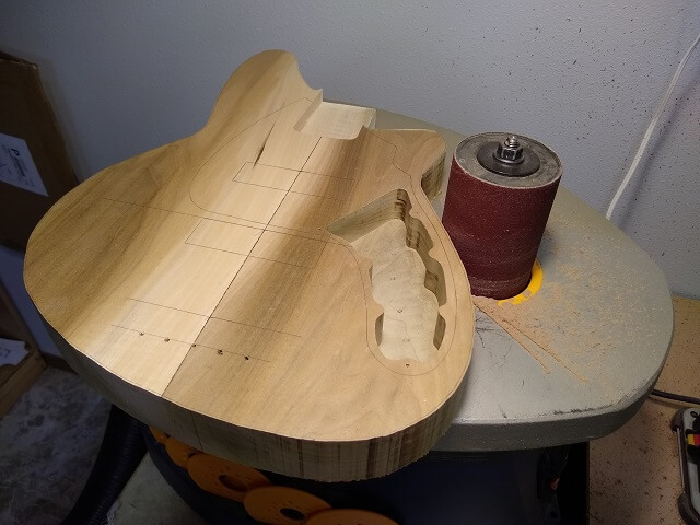 Sanding the body to final shape.