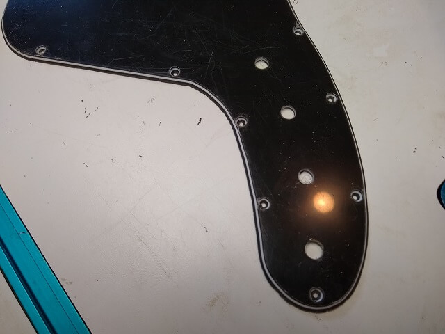 The control holes drilled in the pickguard.