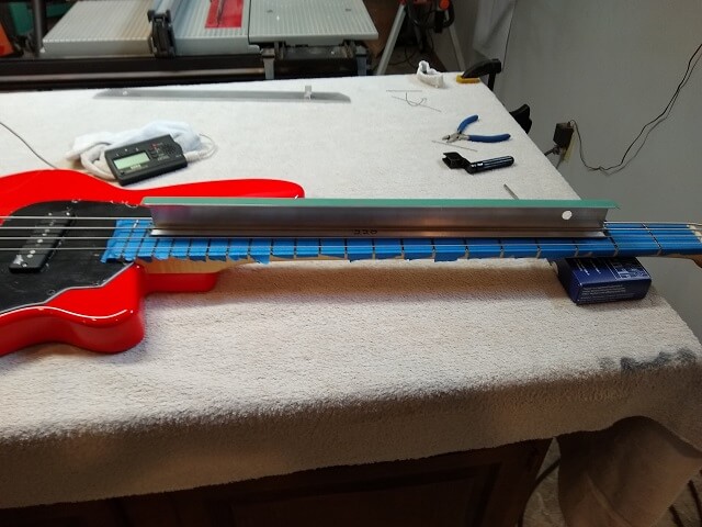Leveling the frets.