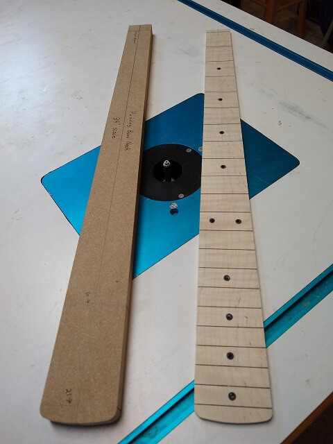Routing the fretboard flush with the template.