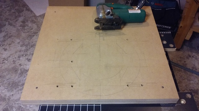 The outer sections of the routing jig with entry holes cut.