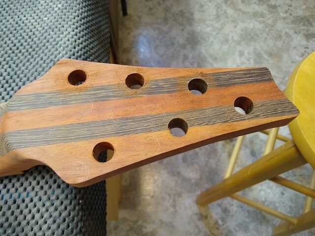 All six tuning key holes after drilling.