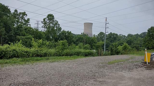 A power plant peeking up from behind the trees on the Ohio River Scenic Byway.
