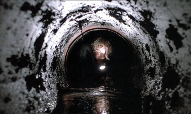 The Shawshank Redemption: Andy crawling through the sewer pipe.