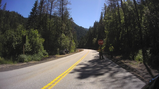 A flagman stopping traffic on highway 12 in Idaho.