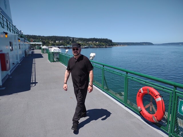 Shawn walking around the sun deck on the ferry.