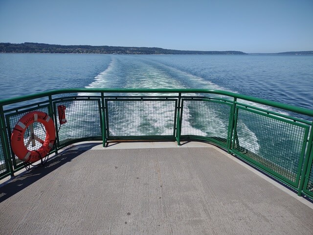 The wake at the back of the ferry.