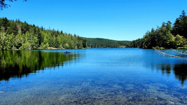 The very calm and clear water of Pass Lake.