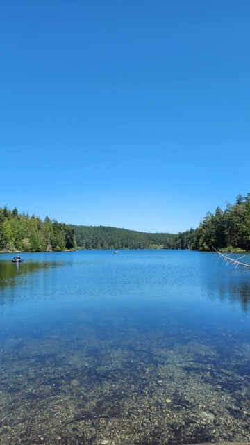 The very calm and clear water of Pass Lake.