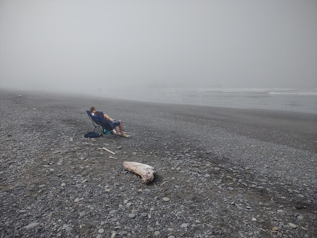 A couple determined to enjoy the beach despite the fog.