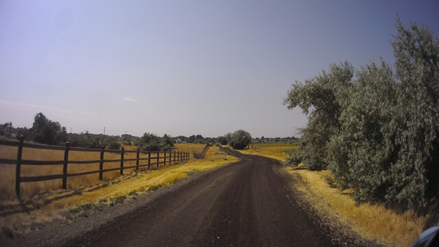 Riding back down the dirt path to get back on the road.