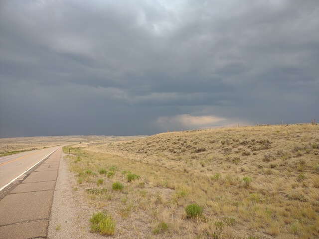 Riding into a storm north of Granger, WY.