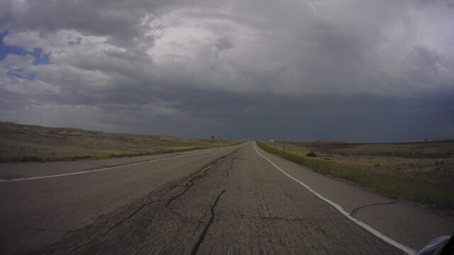 Riding into a storm north of Granger, WY.