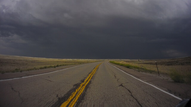 Riding into a storm north of Granger, WY.