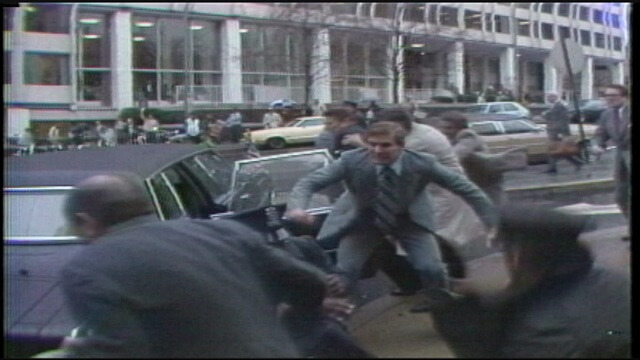 President Reagan being shoved into the presidential limo.