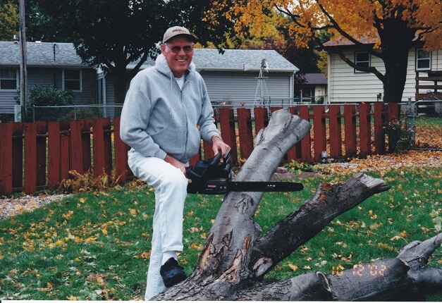 Dad cutting down my maple tree in October, 2002.