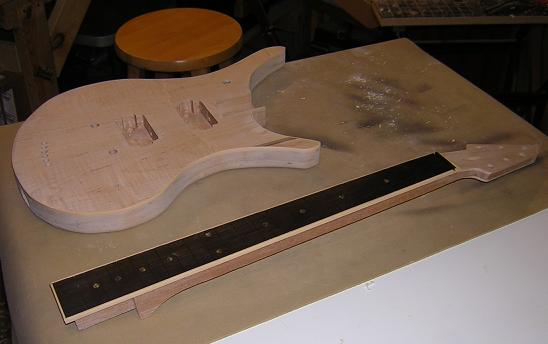Fretboard glued to the neck, and sitting next to the body.