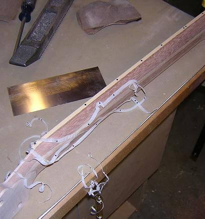 Leveling the fretboard binding with the neck.