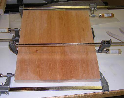 Gluing up the mahogany layer of the body.