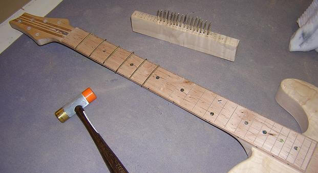 Hammering the frets in place.