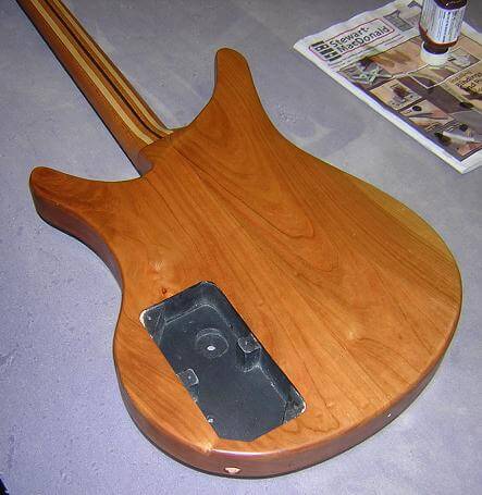 The initial coat of finish on the back of the guitar.