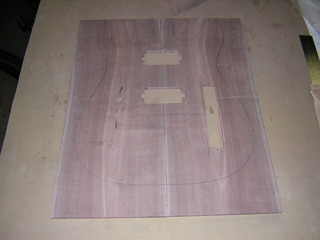 Cutting out the holes for the pickups and control plate.