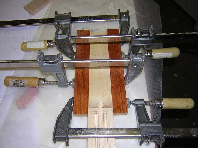 Gluing wings onto the headstock area.