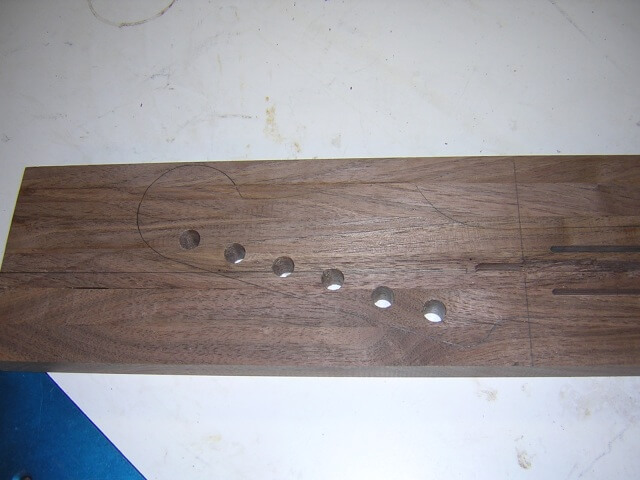 The holes for the tuning keys.