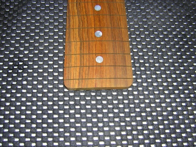 Rounding the end of the fretboard.