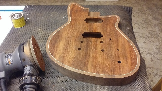 Sanding the front of the guitar.