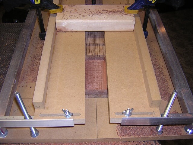 The routed neck pocket still in the jig.
