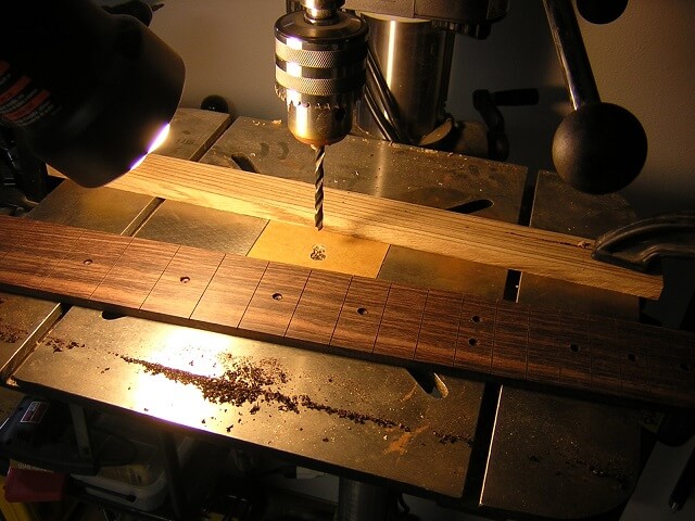 Drilling the holes for the dot inlays.